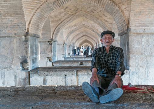 Old man resting under Khaju bridge Pol-e Khaju, Isfahan Province, Isfahan, Iran