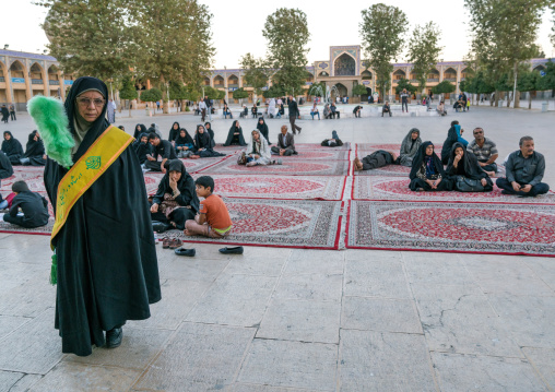 Female guard with a green feather duster at the Mausoleum of Shah-e-Cheragh, Fars Province, Shiraz, Iran
