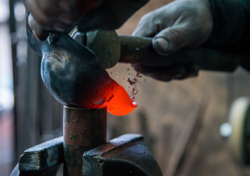 master safar fooladgar creating an alam in his workshop, Central district, Tehran, Iran