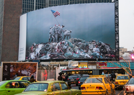 parody of raising the flag on iwo jima historic picture on valiasr square showing american marines on dead bodies, Central district, Tehran, Iran