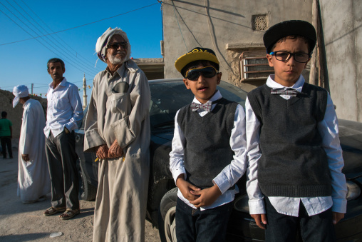 boys dressed in western way during a traditional iranian wedding, Qeshm Island, Salakh, Iran