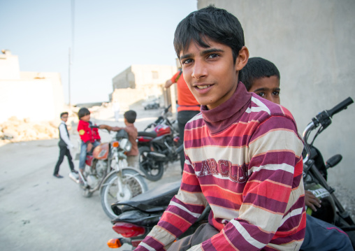 boy sit on a motorbike, Qeshm Island, Salakh, Iran