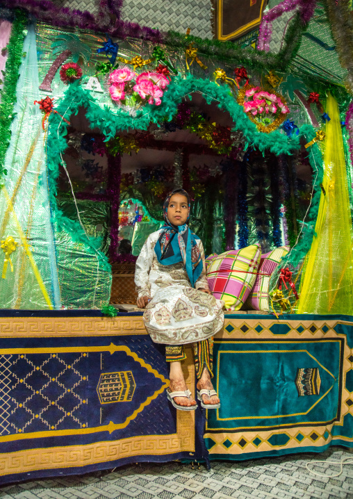 little girl sitting on the bed of the bride and groom room for a wedding, Qeshm Island, Salakh, Iran