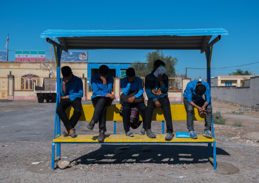 schoolboys waiting for the bus, Hormozgan, Bandar-e Kong, Iran