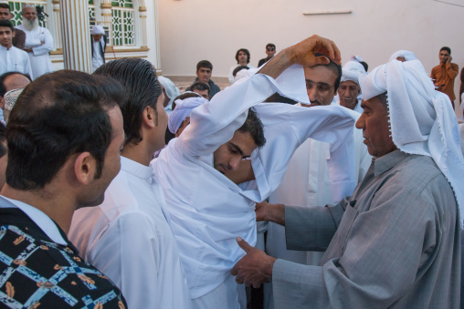 groom changing his clothes to wear new ones during the wedding ceremony, Hormozgan, Bandar-e Kong, Iran