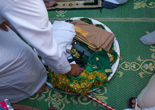 new clothes for the groom during a wedding ceremony, Hormozgan, Bandar-e Kong, Iran