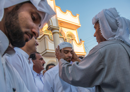 groom changing his clothes to wear new ones during the wedding ceremony, Hormozgan, Bandar-e Kong, Iran