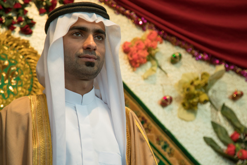groom posing with his new traditional clothes during a wedding ceremony, Hormozgan, Bandar-e Kong, Iran