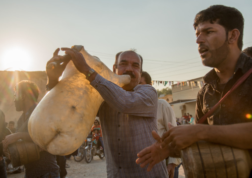 men dancing and playing sheep skin pipe bag during a wedding ceremony, Hormozgan, Kushkenar, Iran