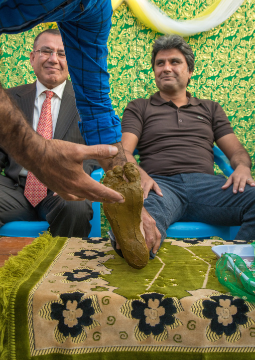 groom being covered with henna during his wedding ceremony, Hormozgan, Kushkenar, Iran