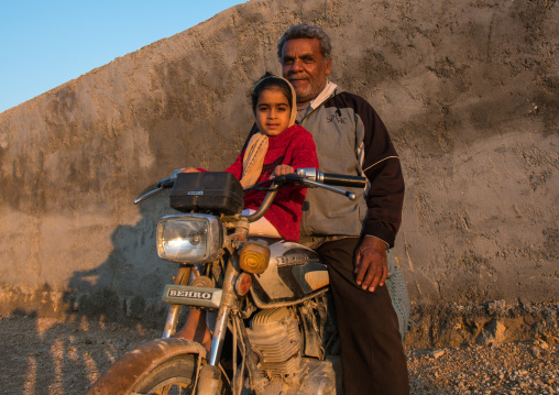 father and daughter on motorbike, Hormozgan, Kushkenar, Iran