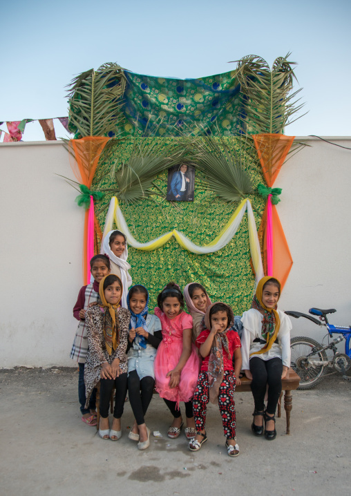 girls in front of a set for a wedding in the street, Hormozgan, Kushkenar, Iran