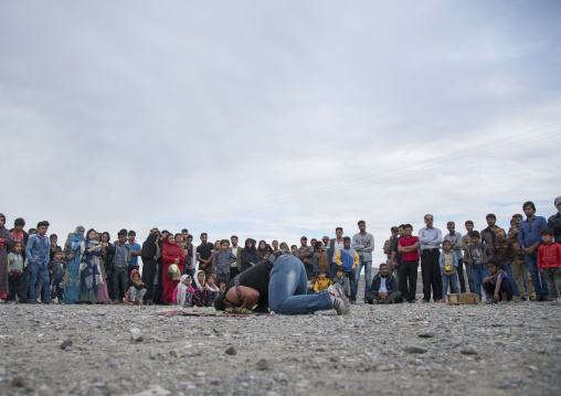 a strongman prays before struggling to break free of chains at the panjshambe bazar, Hormozgan, Minab, Iran
