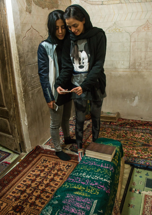 iranian women taking selfie in the meditation room of the tomb of shah nematollah vali, Kerman province, Mahan, Iran