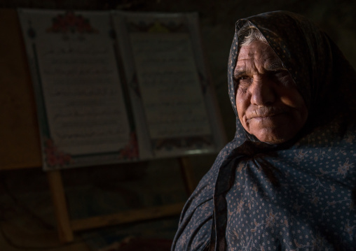 old widow woman inside the mosque of the troglodyte village, Kerman province, Meymand, Iran