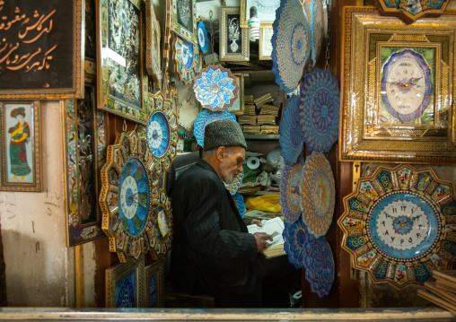 old man reading koran in his shop, Isfahan Province, isfahan, Iran