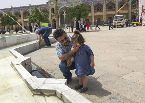 Father and daughter making ablutions in the shah-e-cheragh mausoleum, Fars province, Shiraz, Iran