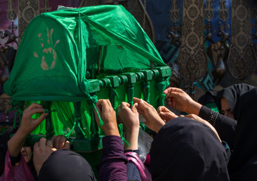 Iranian Shiite Women Putting Gren Ribbons On A Green Craddle To Make Wishes During Chehel Menbari Festival On Tasua Day, Lorestan Province, Khorramabad, Iran