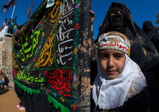 Iranian Shiite Muslim Girl Covered In Mud During Ashura, The Day Of The Death Of Imam Hussein, Kurdistan Province, Bijar, Iran