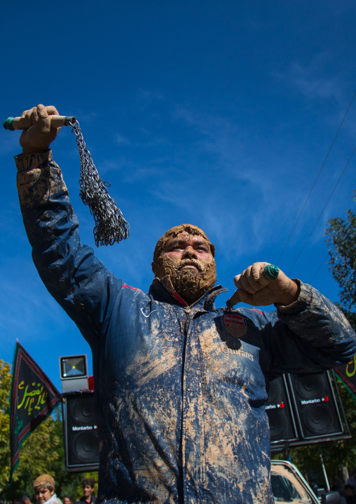 Iranian Shiite Man Covered In Mud Is Beating Himself With Iron Chains To Commemorate Ashura, The Day Of The Death Of Imam Hussein, Kurdistan Province, Bijar, Iran