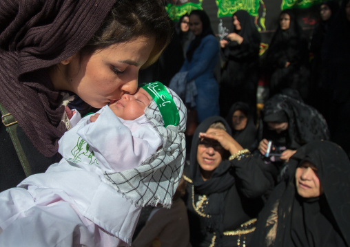Iranian Shiite Muslim Woman Kissing Her Baby During Ashura Celebration, The Day Of The Death Of Imam Hussein, Kurdistan Province, Bijar, Iran