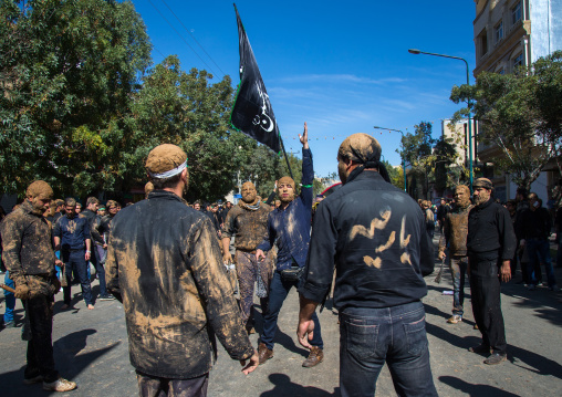 Iranian Shiite Men Covered In Mud Are Beating Themselves With Iron Chains During Ashura, The Day Of The Death Of Imam Hussein, Kurdistan Province, Bijar, Iran
