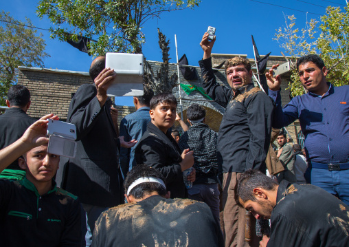 Iranian Shiite Men Covered In Mud Taking Pictures Of The Men Who Are Beating Themselves With Iron Chains To Commemorate Ashura, Kurdistan Province, Bijar, Iran