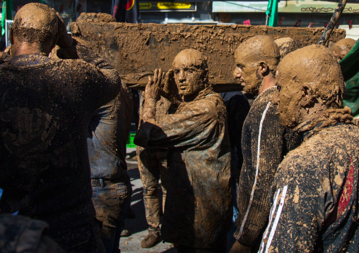Iranian Shiite Muslim Men Covered In Mud Carrying A Coffin During Ashura, The Day Of The Death Of Imam Hussein, Kurdistan Province, Bijar, Iran