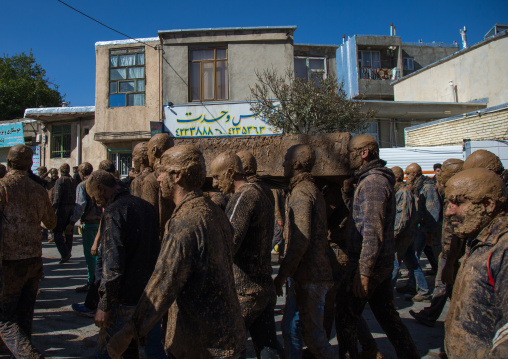 Iranian Shiite Muslim Men Covered In Mud Carrying A Coffin During Ashura, The Day Of The Death Of Imam Hussein, Kurdistan Province, Bijar, Iran