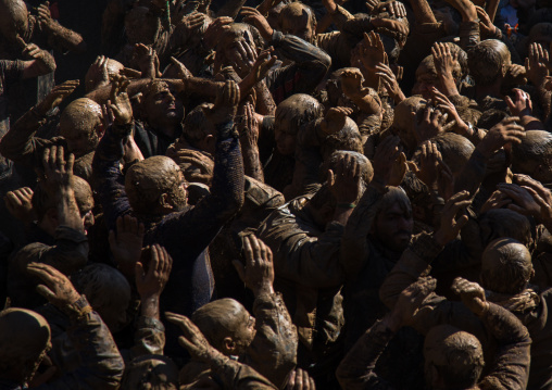 Iranian Shiite Muslim Men Covered In Mud, Chanting And Self-flagellating During Ashura, The Day Of The Death Of Imam Hussein, Kurdistan Province, Bijar, Iran