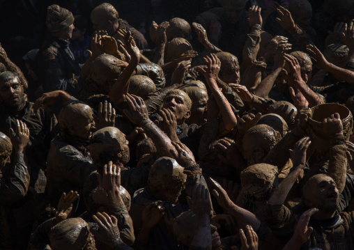 Iranian Shiite Muslim Men Covered In Mud, Chanting And Self-flagellating During Ashura, The Day Of The Death Of Imam Hussein, Kurdistan Province, Bijar, Iran