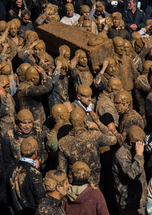 Iranian Shiite Muslim Men Covered In Mud Carrying A Coffin During Ashura, The Day Of The Death Of Imam Hussein, Kurdistan Province, Bijar, Iran