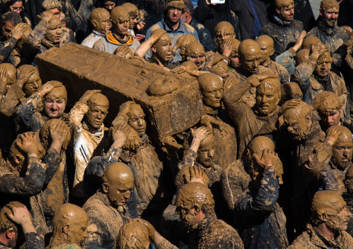 Iranian Shiite Muslim Men Covered In Mud Carrying A Coffin During Ashura, The Day Of The Death Of Imam Hussein, Kurdistan Province, Bijar, Iran