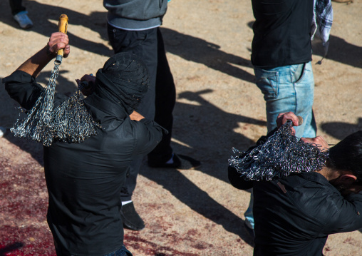Iranian Shiite Men Covered In Mud Are Beating Themselves With Iron Chains During Ashura, The Day Of The Death Of Imam Hussein, Kurdistan Province, Bijar, Iran