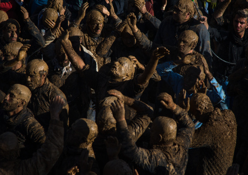 Iranian Shiite Muslim Men Covered In Mud, Chanting And Self-flagellating During Ashura, The Day Of The Death Of Imam Hussein, Kurdistan Province, Bijar, Iran