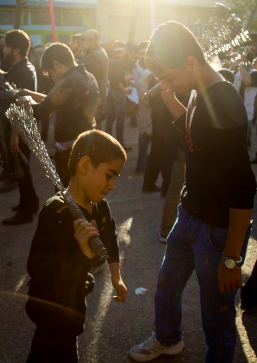 Iranian Shiite Men And Children Covered In Mud Are Beating Themselves With Iron Chains During Ashura, The Day Of The Death Of Imam Hussein, Kurdistan Province, Bijar, Iran