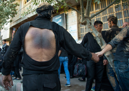 Iranian Shiite Man Covered In Mud Who Has Beaten Himself His Back With Iron Chains During Ashura, The Day Of The Death Of Imam Hussein, Kurdistan Province, Bijar, Iran