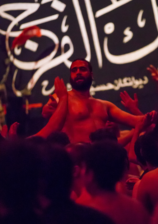 Iranian Shiite Muslim Man Leading Recitations And Songs With The Mad Of Hussein Mourners During Muharram, Isfahan Province, Kashan, Iran