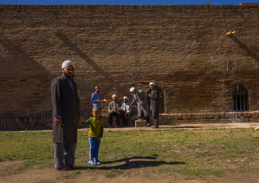 Iranian Shiite Men With A Child In Front Of An Old Caravanserai Turned Into Madrassah, Golestan Province, Karim Ishan, Iran