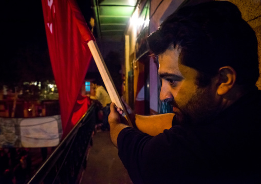 Iranian Shiite Muslims Man Holding A Red Flag During Ashura, The Day Of The Death Of Imam Hussein, Golestan Province, Gorgan, Iran