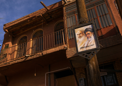 Khameini And Khomeini Poster In Front Of An Ancient Building In Zoroastrian Village, Isfahan Province, Abyaneh, Iran