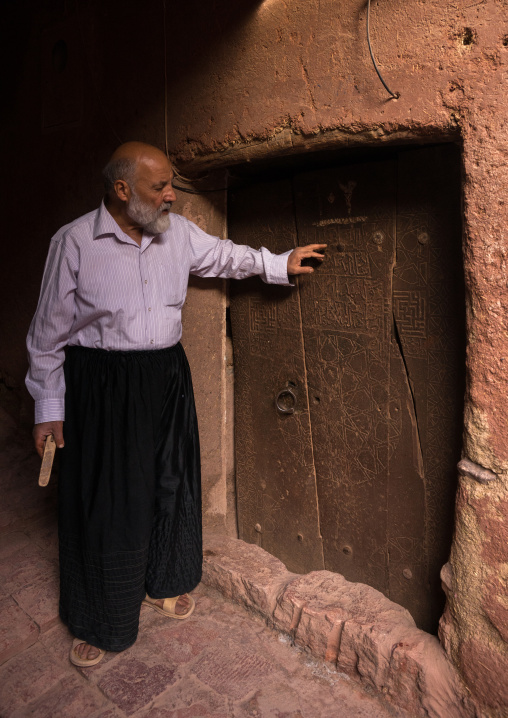 Old Man Opening A Door In Zoroastrian Village, Isfahan Province, Abyaneh, Iran
