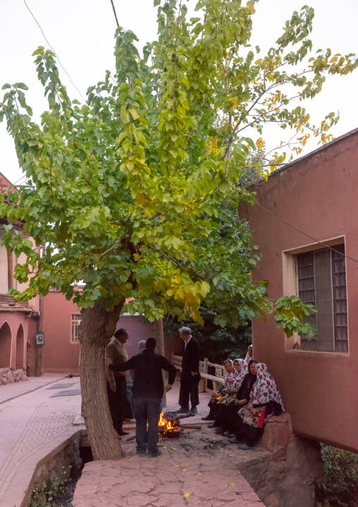 Portrait Of Iranian Women Wearing Traditional Floreal Chadors And Men In Zoroastrian Village, Isfahan Province, Abyaneh, Iran