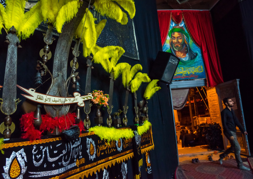 An Alam Near An Imam Hussein Portrait On Ashura, Isfahan Province, Kashan, Iran