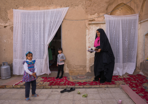 An Afghan Refugee Mother With Her Daughters In Their Home Courtyard, Isfahan Province, Kashan, Iran