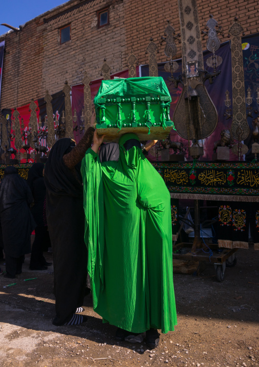 Iranian Shiite Muslim Woman On The Day Of Tasua With Her Face Covered By A Green Veil And Collecting Money In A Craddle, Lorestan Province, Khorramabad, Iran