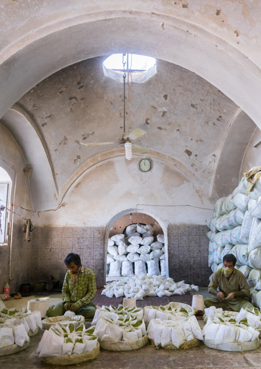 Men Packing Henna Bags In A Traditional Mill, Yazd Province, Yazd, Iran