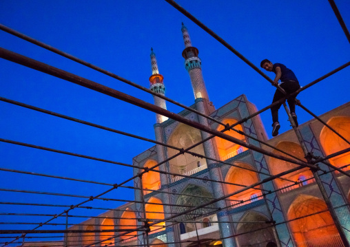 Man Sitting On A Scaffolding In Front Of The Three-storey Takieh Part Of The Amir Chakhmaq Complex, Yazd Province, Yazd, Iran