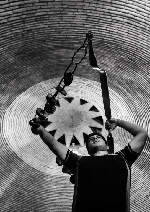 Iranian Man Training With Kabbadeh Chain And Bow At Saheb A Zaman Club Zurkhaneh, Yazd Province, Yazd, Iran