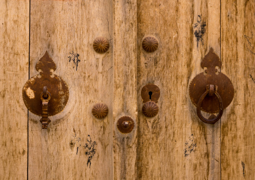 Male And Female Doorknockers On An Old Wooden Door, Fars Province, Abarkooh, Iran
